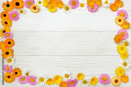 Flowers composition. Frame made of various yellow flowers on white background. Easter, spring, summer concept. Flat lay, top view,