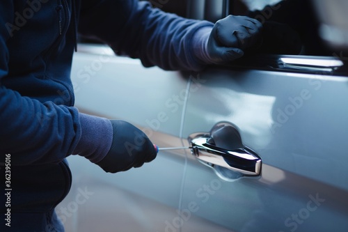 Thief break into a car with a screwdriver. © Chaipong