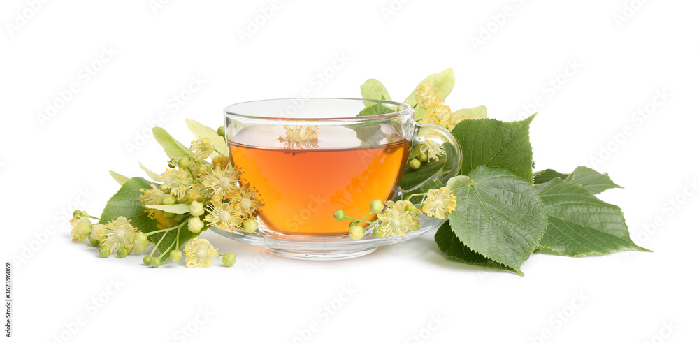 Cup of tea, linden leaves and blossom on white background Cup of tea, linden leaves and blossom on white background
