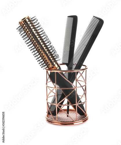 New modern hair brush and combs in metal holder isolated on white
