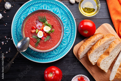  classic spanish raw eating cold soup Gazpacho served at black wooden  table. flat lay. food recipe. healthy concept. photo