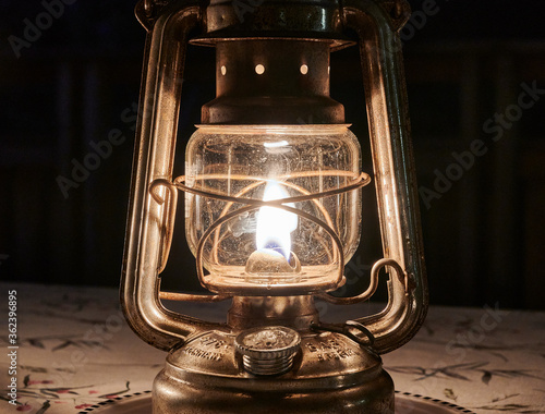 Old kerosene lamps illuminate the summer evening on the patio photo