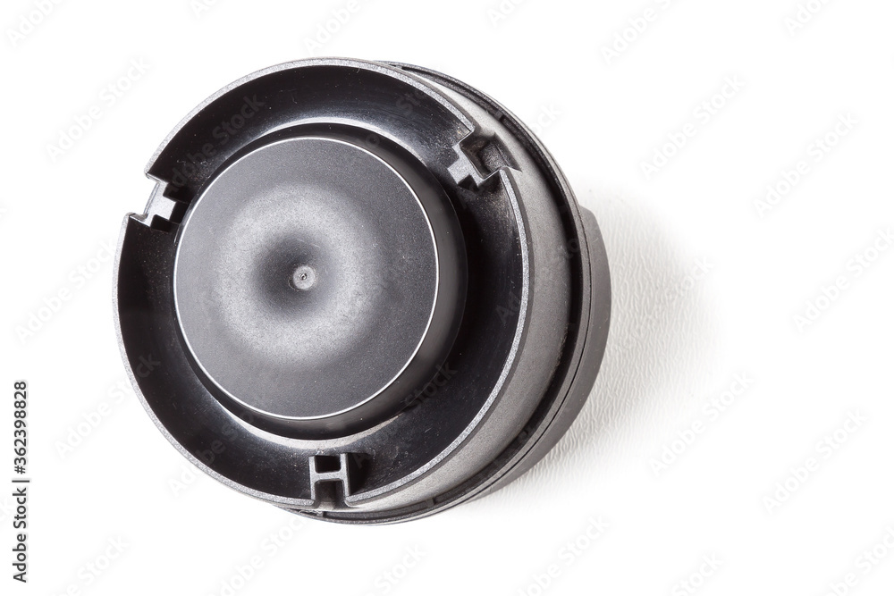 New modern electric black plastic beep - car horn on a white isolated background in a photo studio. Spare part for sale or repair in a workshop or tuning the sound of a beep in a car service.
