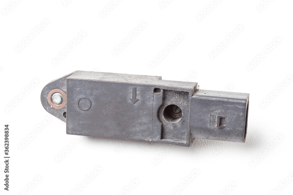 The removed spare part from the car on a white isolated background is an impact sensor when airbags are deployed in a black plastic case for replacement and repair. Spare parts catalog. The removed spare part from the car on a white isolated background is an impact sensor when airbags are deployed in a black plastic case for replacement and repair. Spare parts catalog.