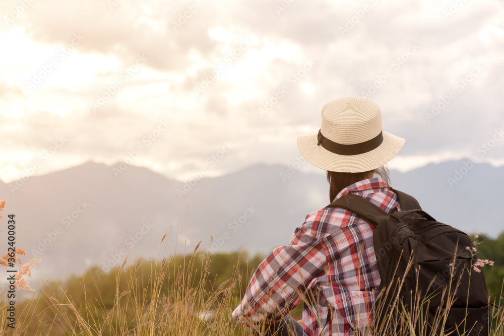 woman traveler with backpacker sitting on top of mountain woman traveler with backpacker sitting on top of mountain