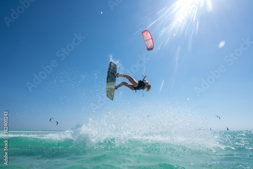 Kite girl rides in the ocean clear water