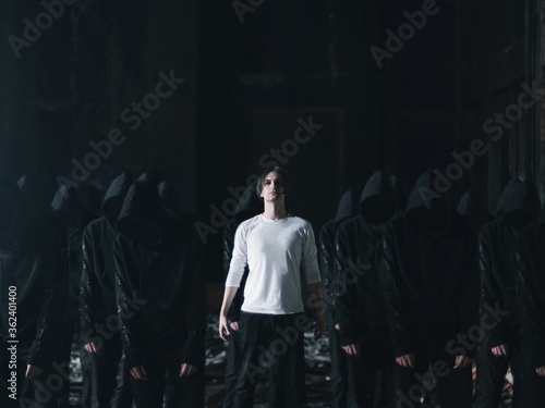Obraz na plátně man in white with followers in black cult concept