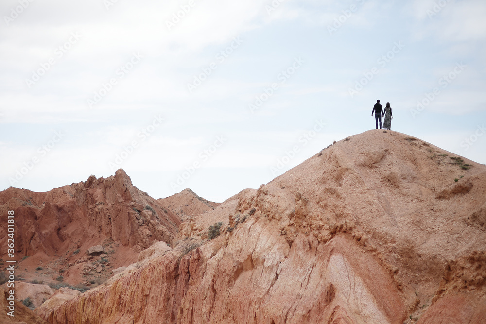 Couple on the top of the mountain. Beautiful mountain landscape. Wildlife of Kyrgyzstan.