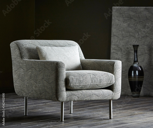 Comfortable armchair with pillow in living room