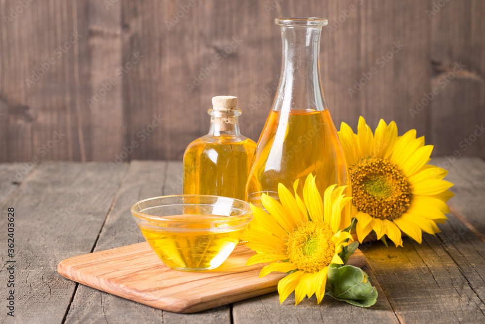 Sunflower oil and sunflower seeds on traditional rustic wooden background. Sunflower oil and sunflower seeds on traditional rustic wooden background.