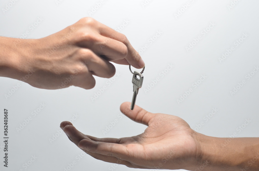 Hand Giving a Key With Isolated White Background Hand Giving a Key With Isolated White Background