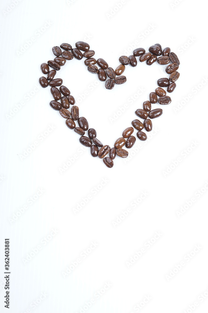 Roasted coffee beans in shape of hart on white background Roasted coffee beans in shape of hart on white background