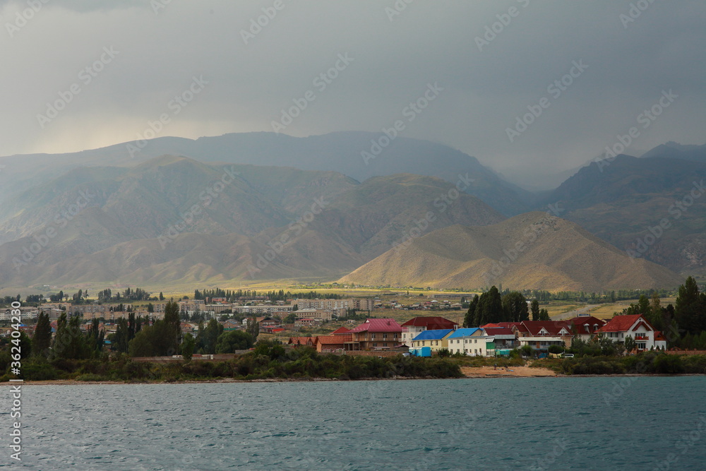 Beautiful mountain landscape. The shore of Lake Issyk-Kul. Wildlife of Kyrgyzstan. Clouds in the sky.
