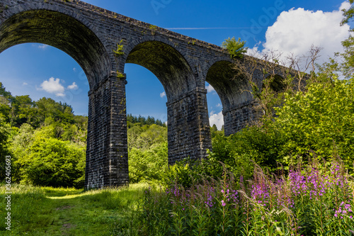 Arches underneath an old Victorian viaduct in a beautiful green rural setting (Pontsarn Viaduct, South Wales, UK) photo