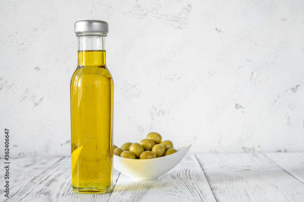 Bottle of olive oil with green olives Bottle of olive oil with green olives