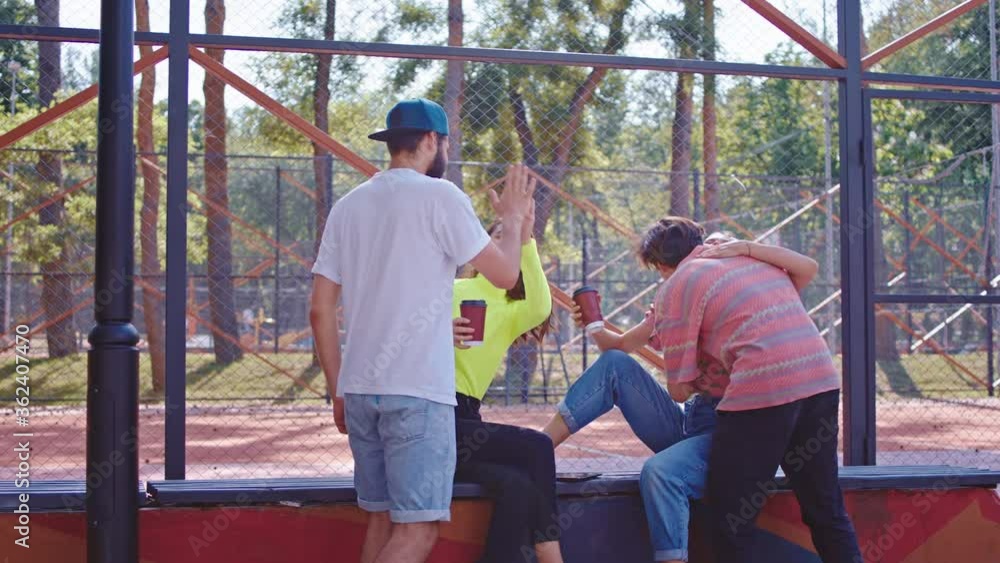 Charismatic ladies and guys multiethnic group of friends meeting all together in the modern skate park they socializing together and smiling large Charismatic ladies and guys multiethnic group of friends meeting all together in the modern skate park they socializing together and smiling large