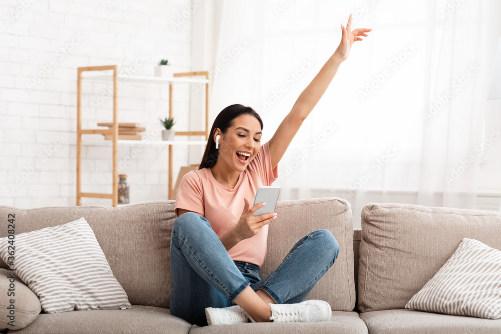 Girl wearing headphones enjoying music with phone Girl wearing headphones enjoying music with phone