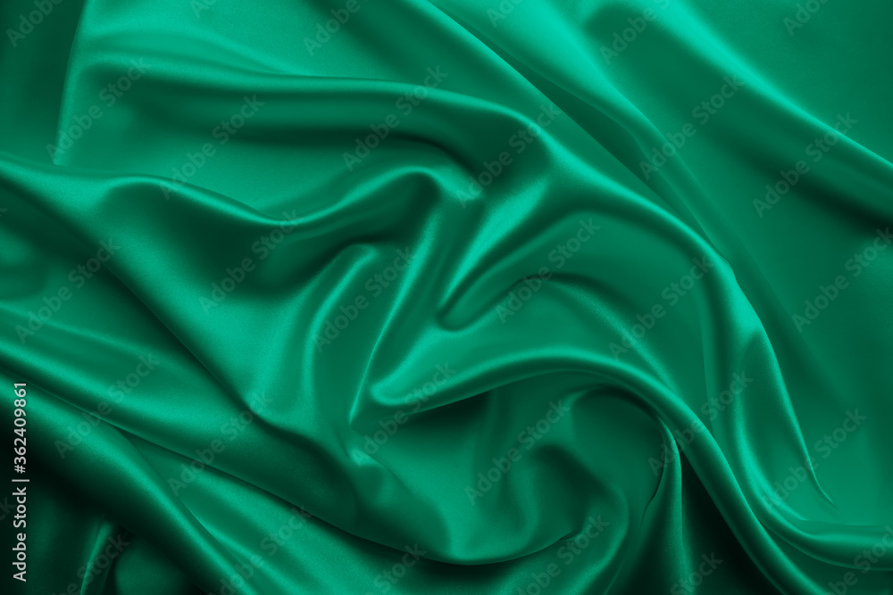 Fototapeta premium Beautiful smooth elegant wavy emerald green satin silk luxury cloth fabric texture, abstract background design. Card or banner. 