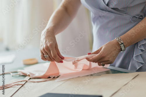 Tailor working with cloth in atelier