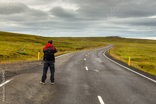 A man taking a picture on Road 36 Road in Iceland.