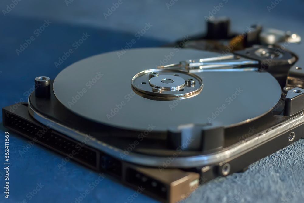 Disassembled hard drive from the computer, hdd with mirror effect. Opened hard drive from the computer hdd with mirror effects. Part of computer pc, laptop. Disassembled hard drive from the computer, hdd with mirror effect. Opened hard drive from the computer hdd with mirror effects. Part of computer pc, laptop.