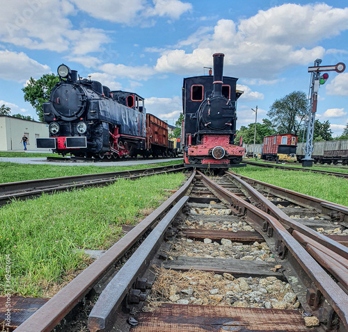 Old steam engine locomotives on narrow gauge tracks in the museum