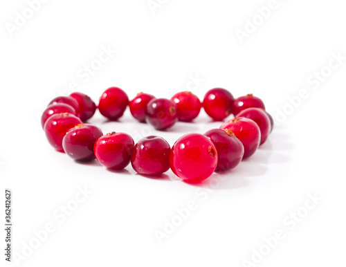 Heart made of cranberries isolated on a white background.