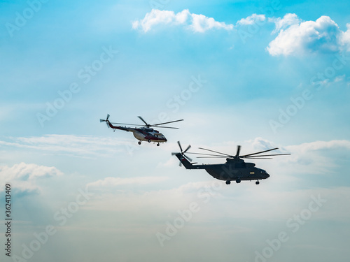 Fototapeta Naklejka Na Ścianę i Meble -  Silhouette of heavy transport helicopter flying against the blue sky