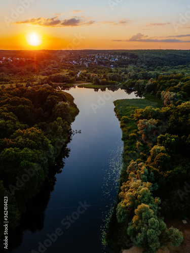 Sunset above the river in natural rural landscape