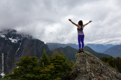 Adventurous Girl on top of a Mountain top with Canadian Nature Landscape in Background. Taken on Evan's Peak, Golden Ears Provincial Park, near Vancouver, BC, Canada. © edb3_16