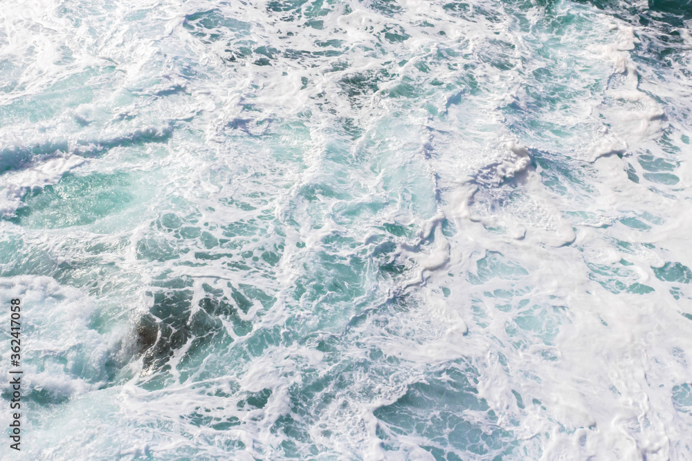 Fototapeta premium Wall mural on the marine theme. Seascape for the interior. White sea foam. The turquoise color of the waves. Stormy Bay of Biscay. The texture of the waves. Spray and the power of the sea.