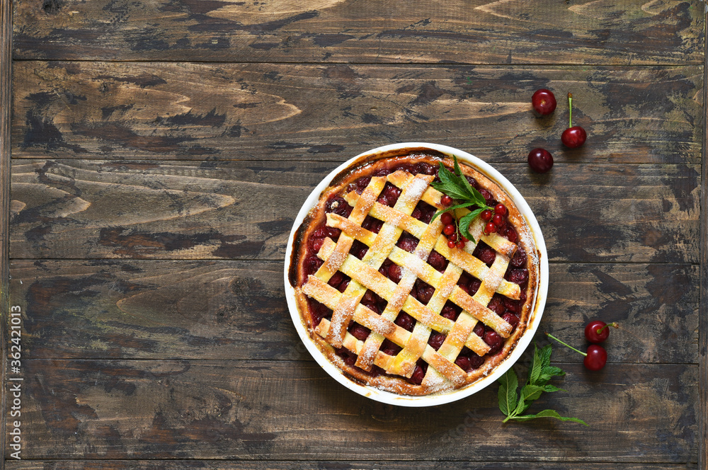 Cherry pie on a wooden background with place for text. View from above. Cherry pie on a wooden background with place for text. View from above.