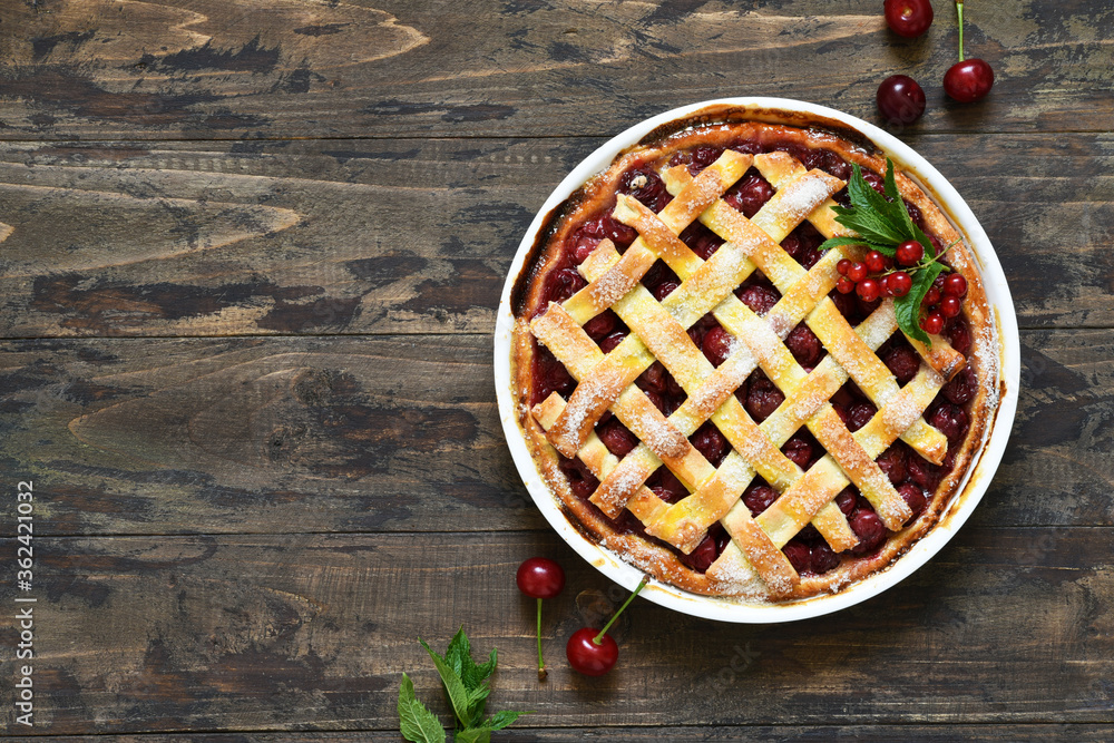 Cherry pie on a wooden background with place for text. View from above. Cherry pie on a wooden background with place for text. View from above.