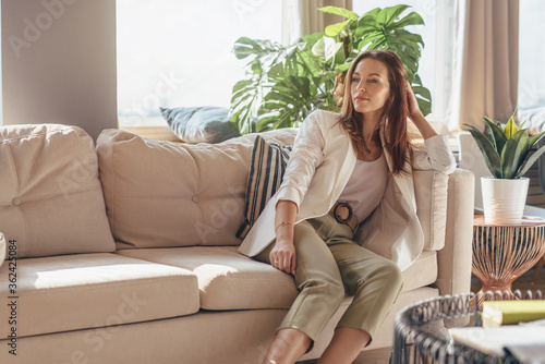 Foto Portrait of business woman at home sitting on couch