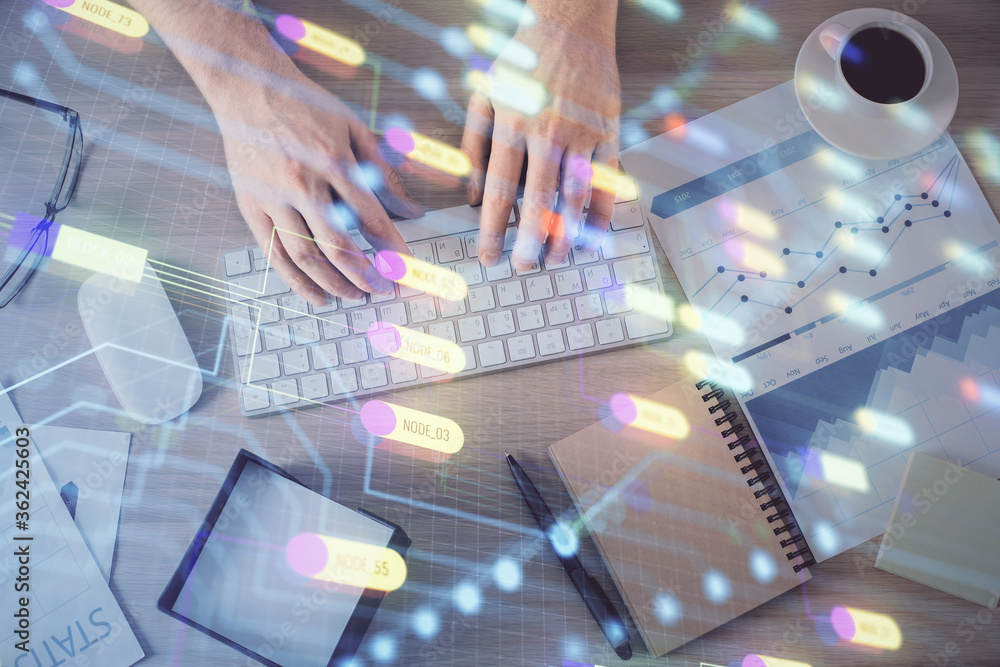 Double exposure of man's hands typing over computer keyboard and data theme hologram drawing. Top view. Technology concept. Double exposure of man's hands typing over computer keyboard and data theme hologram drawing. Top view. Technology concept.