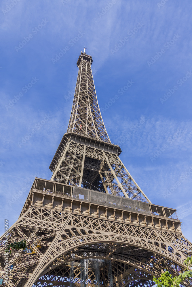 Eiffel Tower (La Tour Eiffel) located on Champ de Mars in Paris, named after engineer Gustave Eiffel. Eiffel Tower is tallest structure in Paris and most visited monument in world. Paris, France.