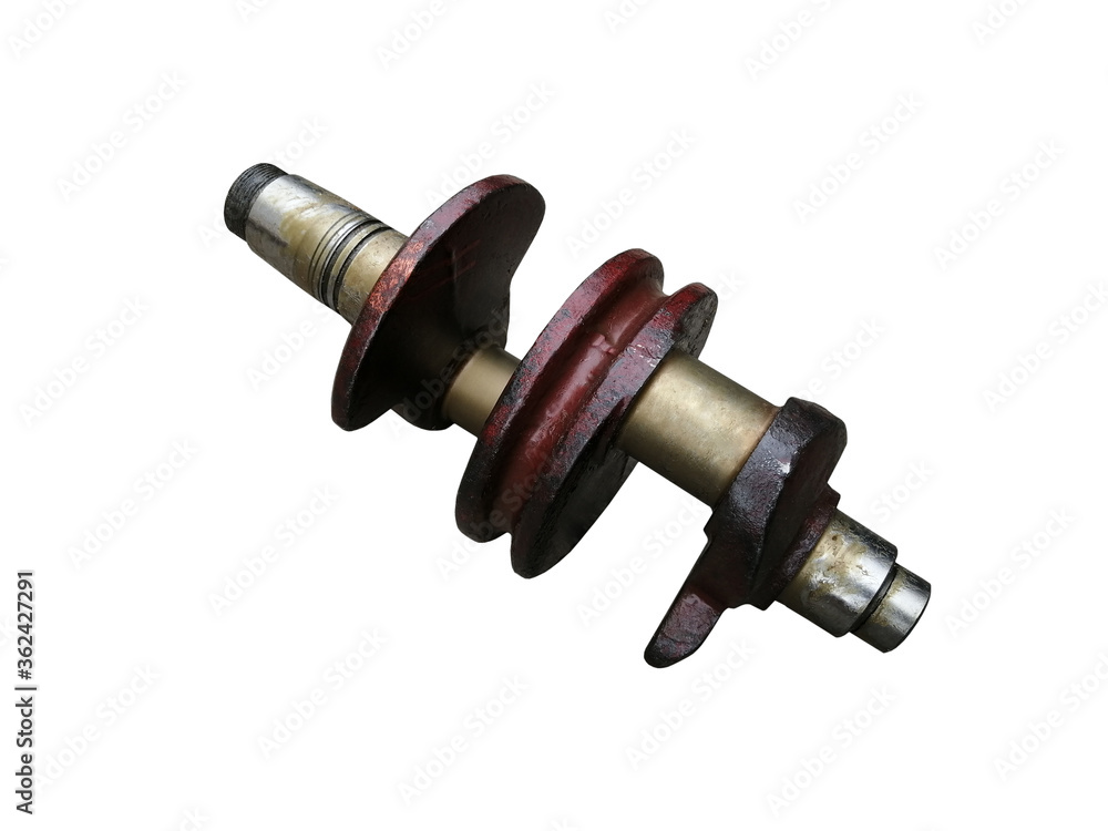 Crankshaft of a two-cylinder tractor engine on an isolated white background. Spare parts. Crankshaft of a two-cylinder tractor engine on an isolated white background. Spare parts.