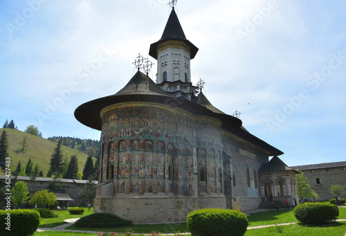 Obraz na płótnie SUCEVITE MONASTERY, BUCOVINA, ROMANIA, EUROPE, SPRING 2018. Orthodox monastery. Moldovan architectural style. Open-air paintings, frescoes and portraits of saints with Byzantine influence. w salonie