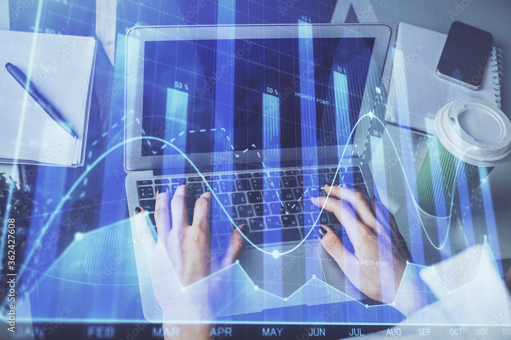 Double exposure of woman hands typing on computer and forex chart hologram drawing. Stock market invest concept. Double exposure of woman hands typing on computer and forex chart hologram drawing. Stock market invest concept.