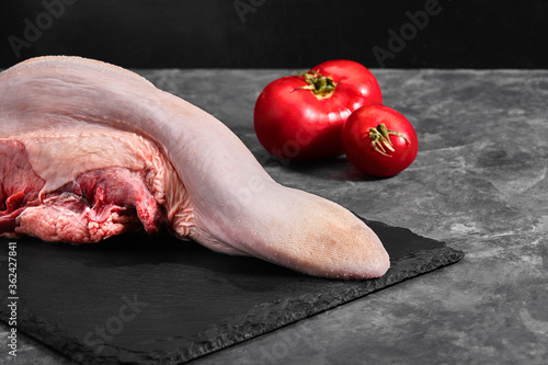 Raw beef tongues on the dark background photo