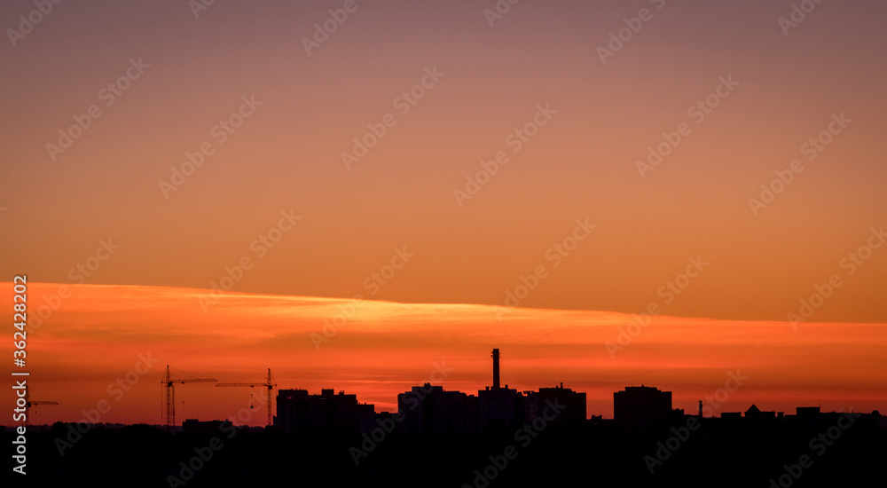 Silhouette panorama at sunset with building and cranes. Vladimir city, Russia
