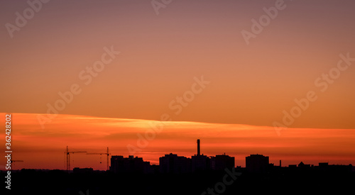 Silhouette panorama at sunset with building and cranes. Vladimir city  Russia