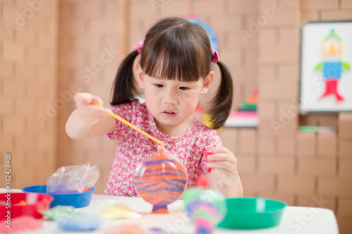 toddler girl making sand animal crafts for homeschooling