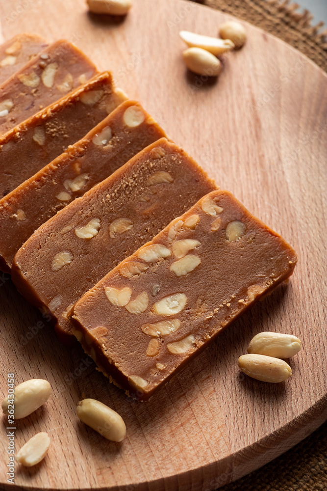 Peanut home toffee on a wooden board. Slices of eastern sweets with nuts. Peanut home toffee on a wooden board. Slices of eastern sweets with nuts.