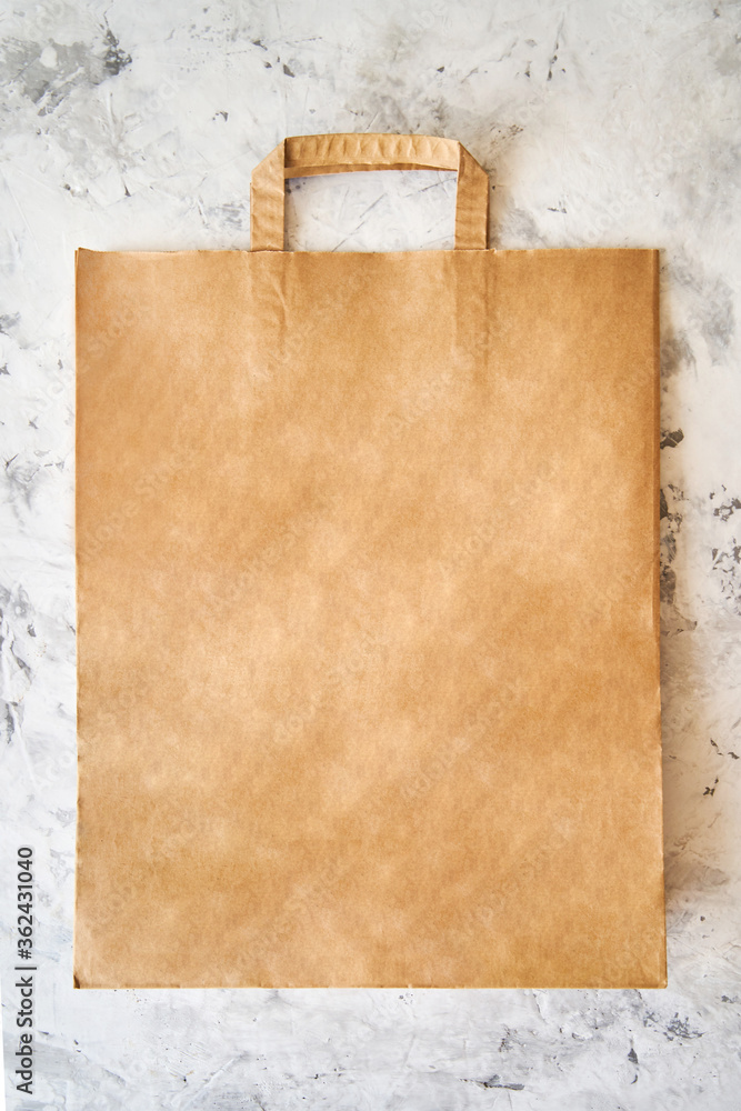 Blank eco brown paper bag on light background. Craft grocery bag. Mockup. Copy space