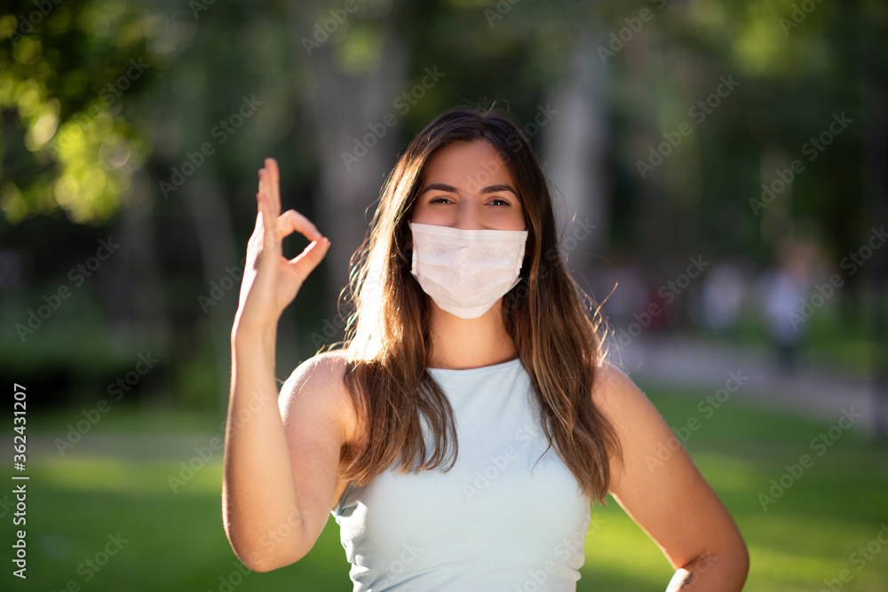 New normal concept, Portrait view of a Modern Turkish woman wears a mask and making okay sign with her hands New normal concept, Portrait view of a Modern Turkish woman wears a mask and making okay sign with her hands