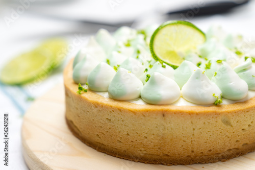 key lime cheese tart with whipping cream on the table