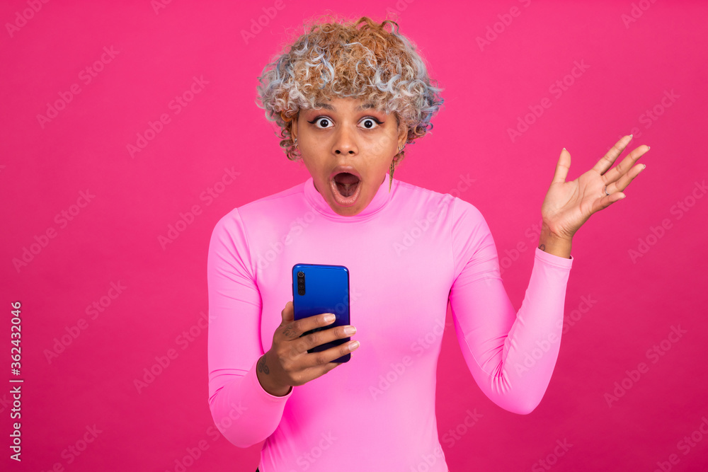 amazed woman with mobile phone isolated on background amazed woman with mobile phone isolated on background