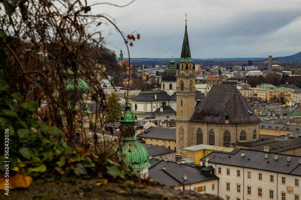 Austria Salzburg moody Europe city landmark view catholic cathedral tower and gray old buildings from above top view point in rainy autumn day