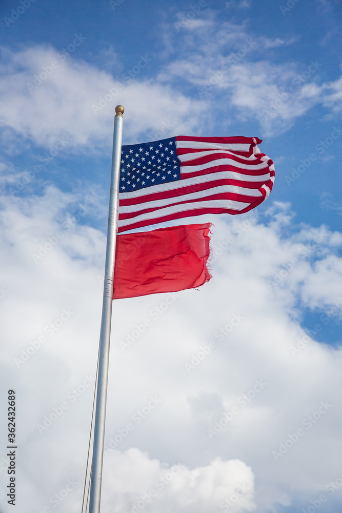 American Flag and Red Flag Flying at the Beach - High Hazard American Flag and Red Flag Flying at the Beach - High Hazard